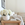 Big flower bouquet of white hydrangeas in a white sandstone vase on a wooden table