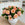 Bouquet of peach roses in a white vase on a kitchen counter